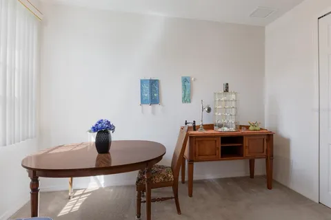 a living room with furniture cabinets and a large window