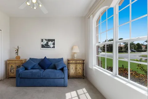 a reading room with furniture and a window