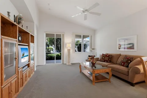 a view of a dining room with furniture a chandelier and wooden floor
