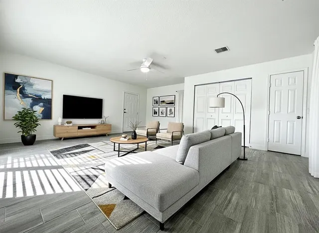 a living room with furniture and a flat screen tv
