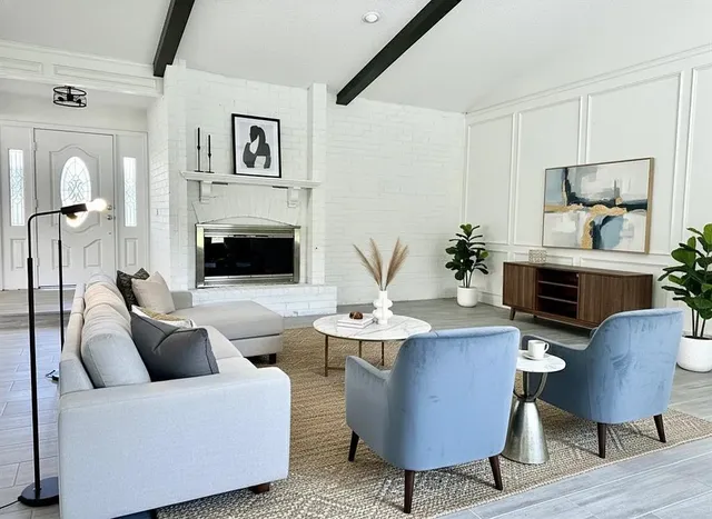 a living room with furniture and a fireplace