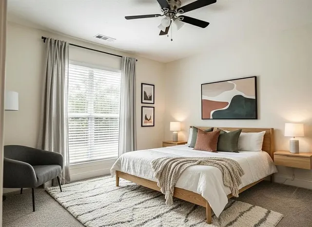 a bedroom with a large bed and a window