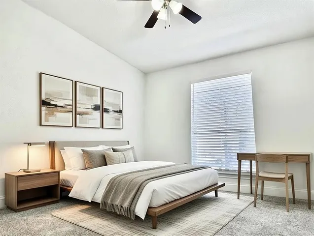 a spacious bedroom with a bed and chair