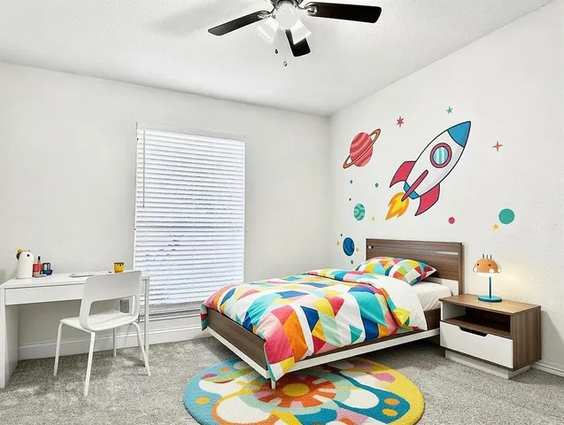 a bedroom with a bed a couch and a chandelier