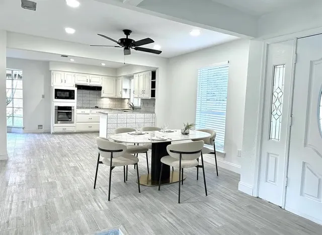 a view of a dining room with furniture and wooden floor