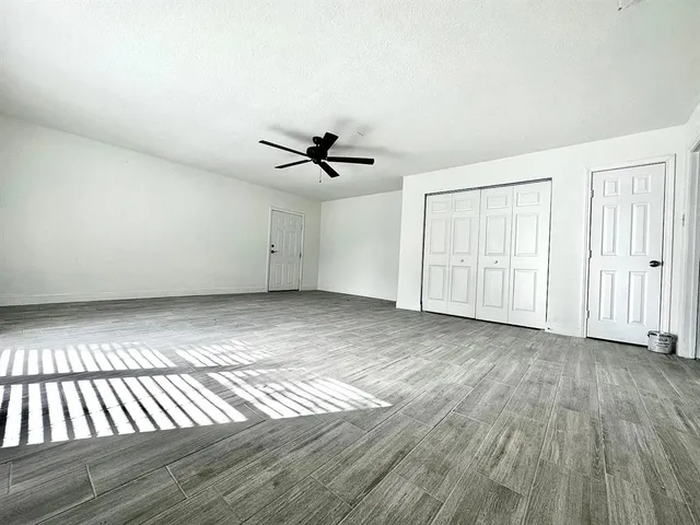 a view of an empty room and wooden floor