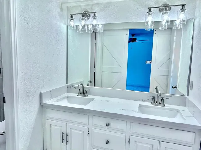 a bathroom with a sink double vanity and a mirror