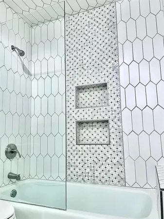 a bathroom with a bathtub and shower
