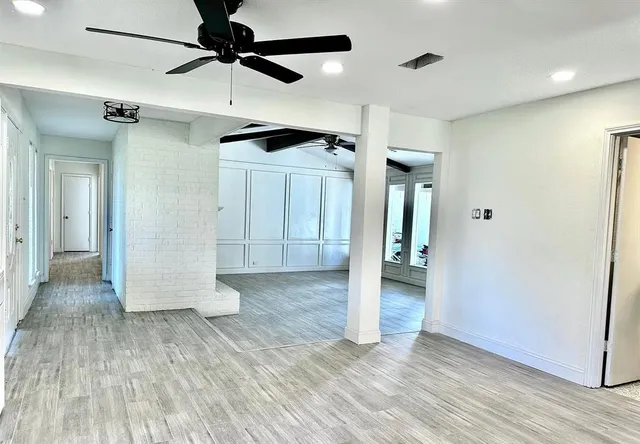 a view of hallway with wooden floor