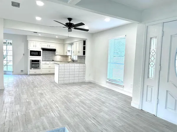 a view of kitchen with sink microwave refrigerator and cabinets