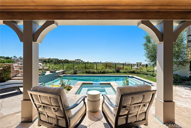 a view of swimming pool with seating area and furniture