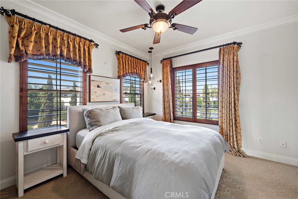 5 Via Monarca Street Dana Point, CA 92629 - Photo 28 of 57 a bedroom with a large bed and a chandelier fan