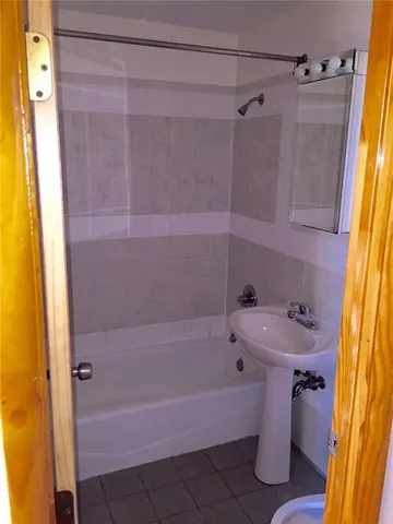 an empty room with wooden floor and closet