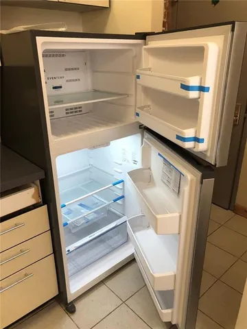 a kitchen with stainless steel appliances a refrigerator a stove a microwave and cabinets