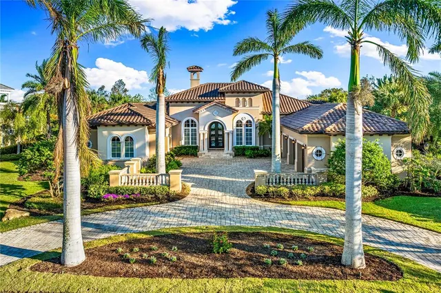 a view of a house with a yard and potted plants