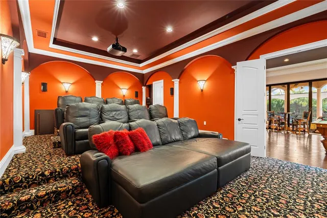a living room with furniture a chandelier and a flat screen tv