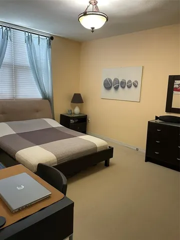 a bedroom with a bed and a desk