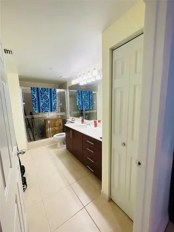 a large bathroom with a double vanity sink and a mirror