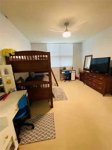 a bedroom with a bed and a television