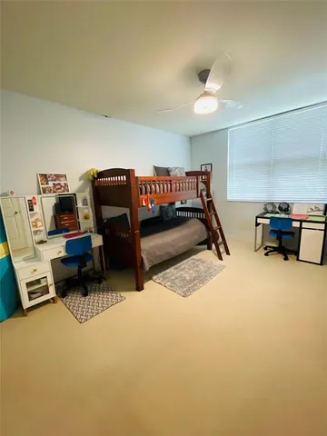 a bedroom with furniture and a air conditioner vent