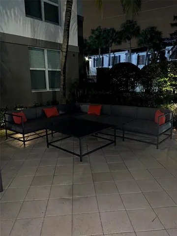 a view of a patio with table and chairs and potted plants
