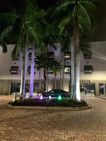 a hallway with wooden floor and windows
