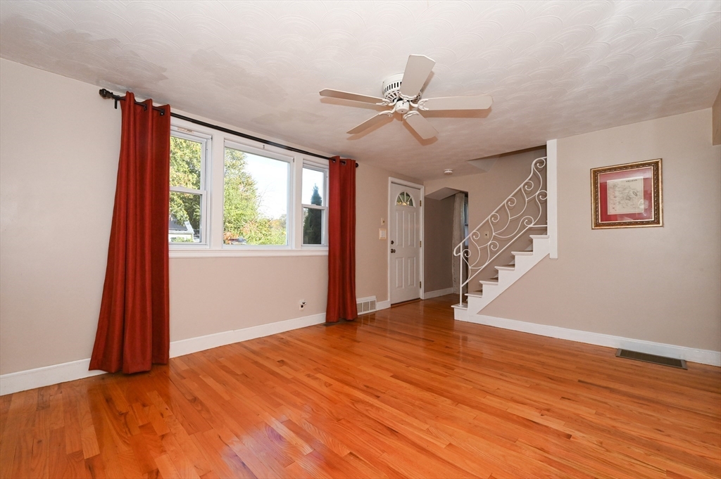 1 Linda Road Sharon, MA 02067 - Photo 3 of 25 a view of an empty room with a window and wooden floor