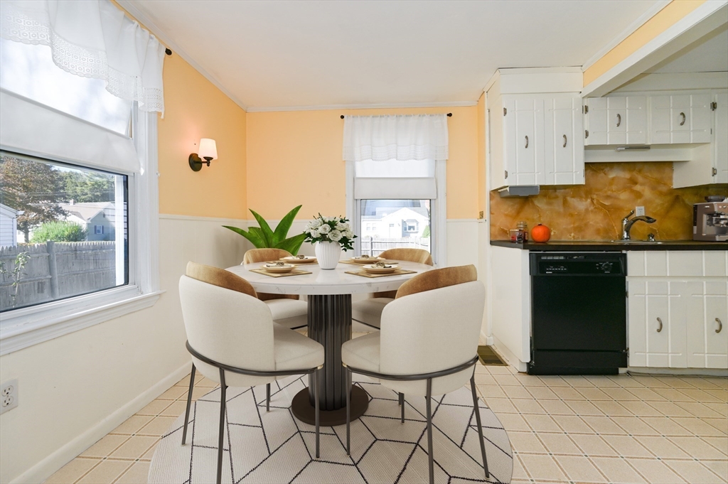1 Linda Road Sharon, MA 02067 - Photo 4 of 25 a kitchen with stainless steel appliances a table and chairs in it