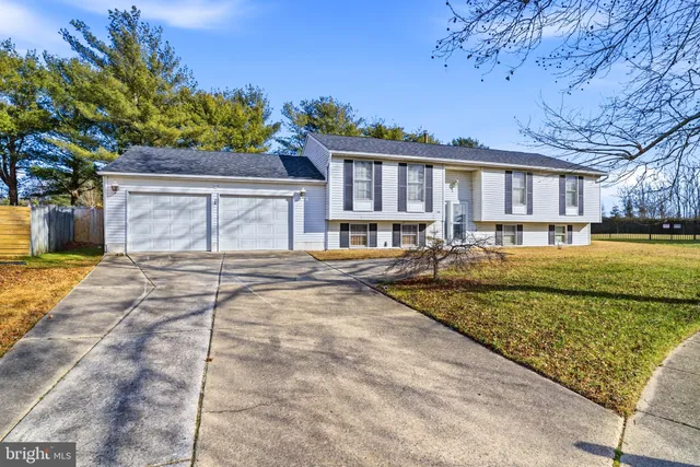 a front view of a house with a yard patio and swimming pool