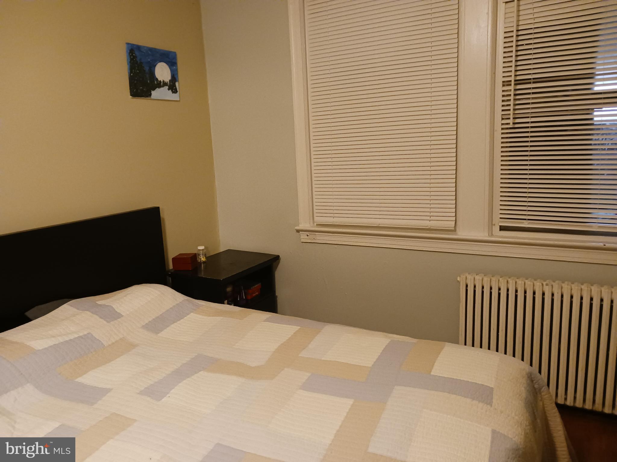 1912 M Street Northeast Washington, DC 20002 - Photo 8 of 12 a bedroom with a bed and a window