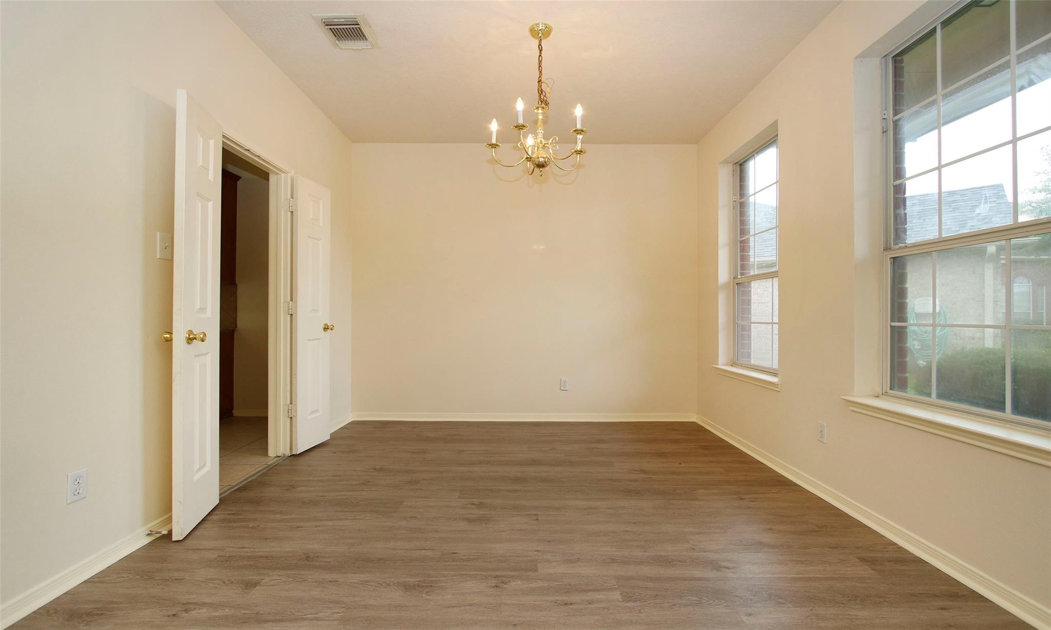 20506 Spring Lilac Lane Spring, TX 77388 - Photo 12 of 33 wooden floor in an empty room with a window