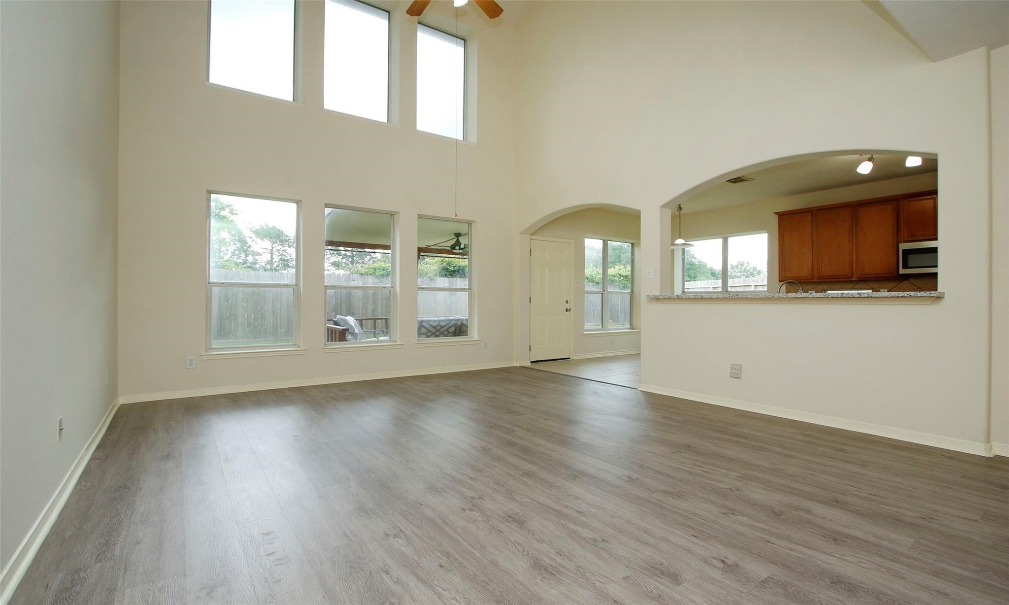20506 Spring Lilac Lane Spring, TX 77388 - Photo 7 of 33 a view of an empty room with wooden floor and a window