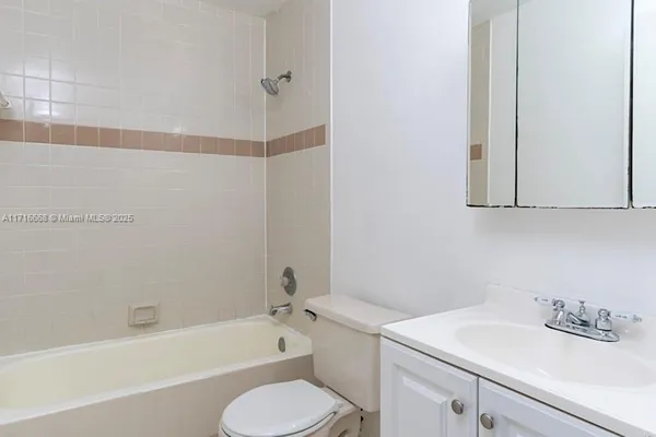 a bathroom with a sink toilet vanity and bathtub