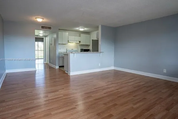 a view of kitchen with refrigerator and window