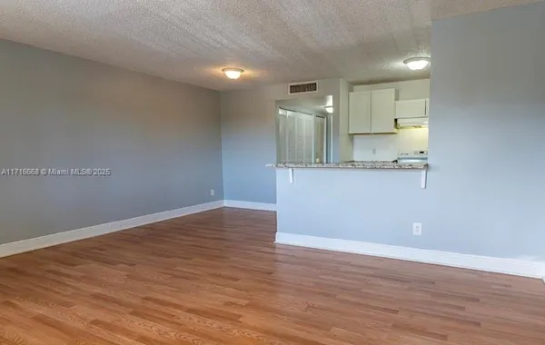 a view of kitchen with wooden floor