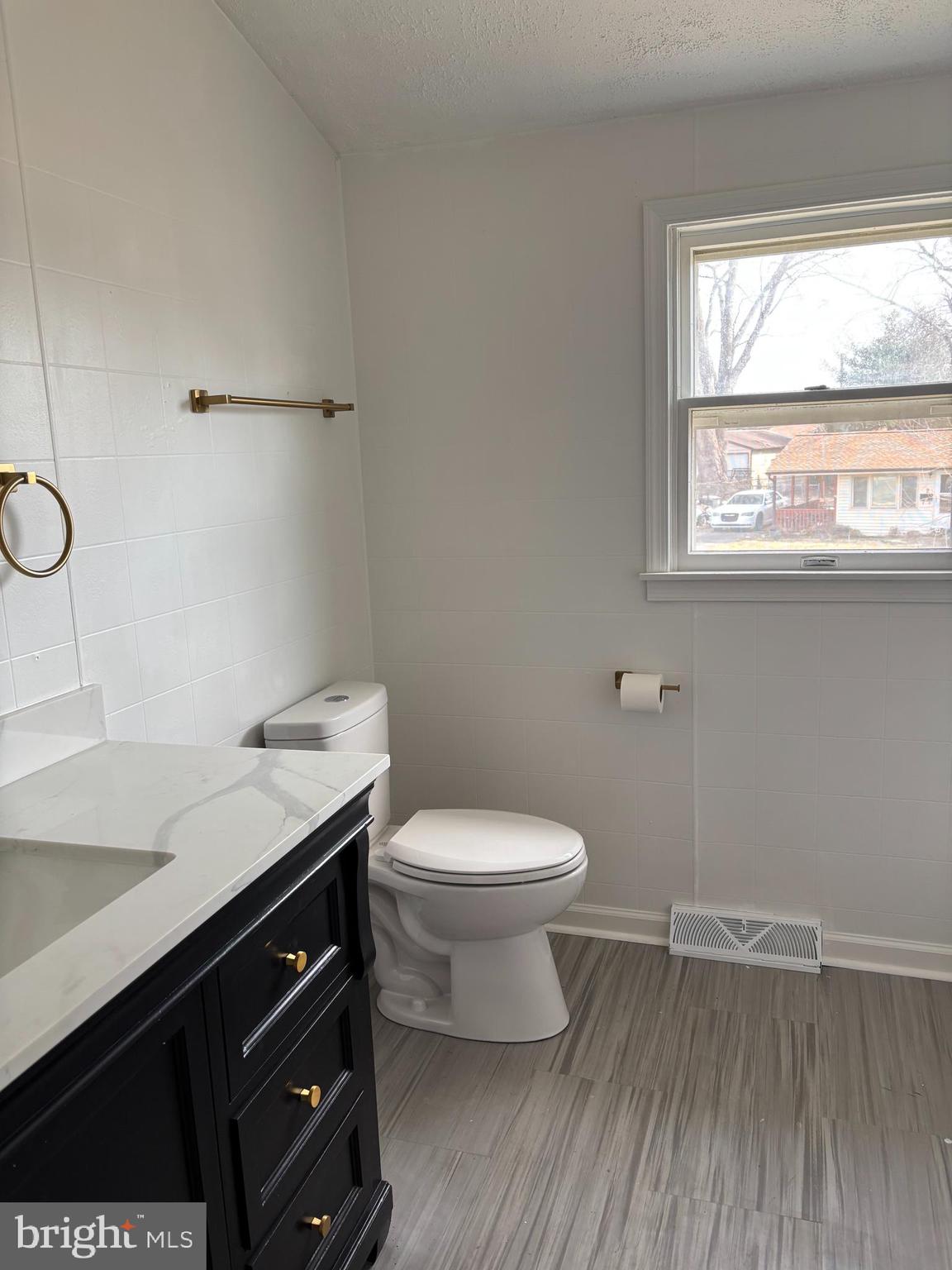 1 Cherry Lane Elkton, MD 21921 - Photo 8 of 12 a bathroom with a granite countertop toilet sink and a window