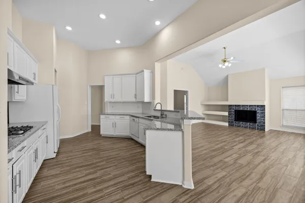 a kitchen with white cabinets and appliances