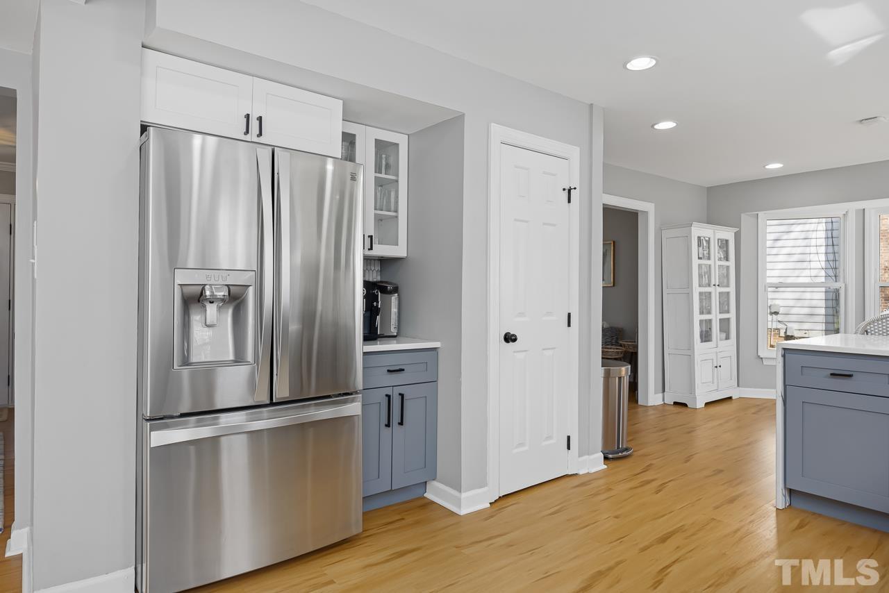4308 Hickory Ridge Drive Raleigh, NC 27609 - Photo 11 of 46 a kitchen with stainless steel appliances a refrigerator and wooden floor