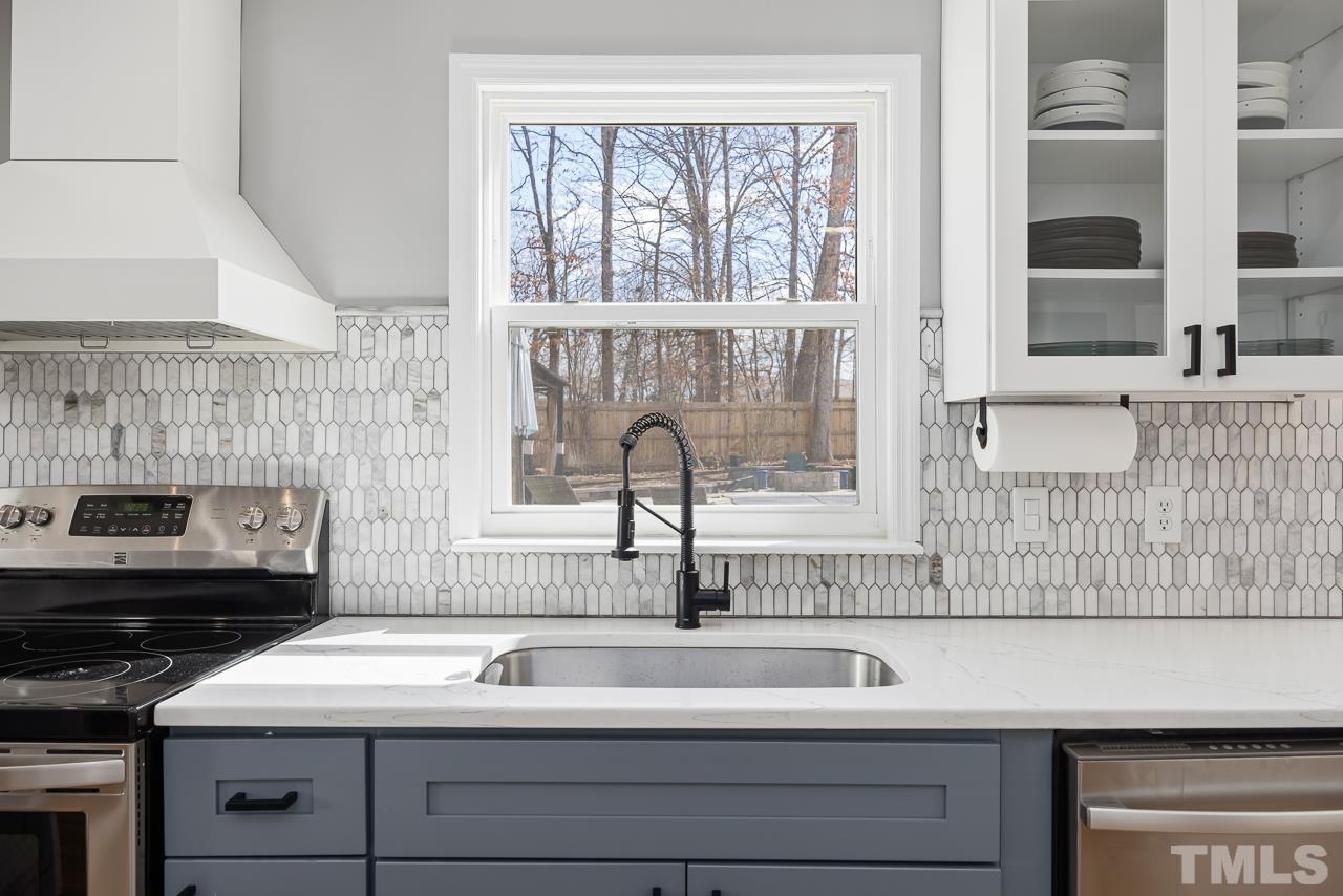 4308 Hickory Ridge Drive Raleigh, NC 27609 - Photo 12 of 46 a close view of a sink and a stove next to a window
