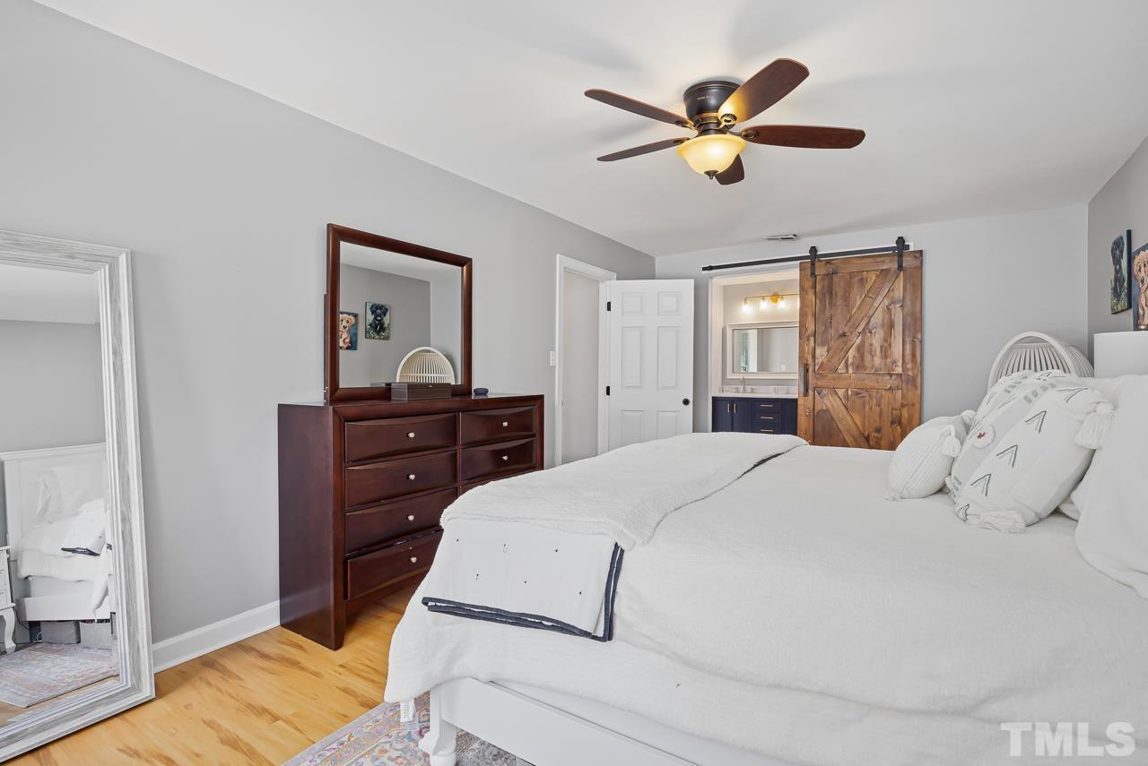 4308 Hickory Ridge Drive Raleigh, NC 27609 - Photo 19 of 46 a bedroom with a bed and a ceiling fan
