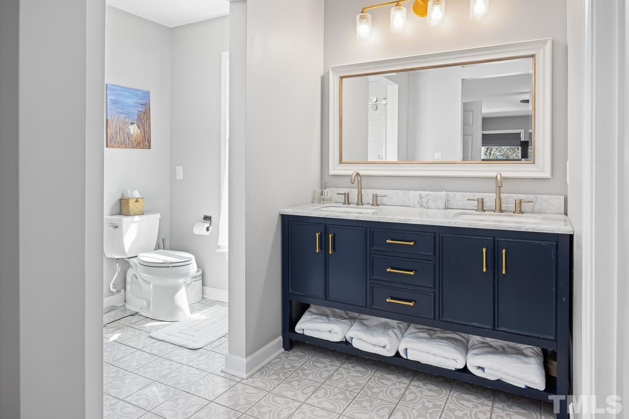 4308 Hickory Ridge Drive Raleigh, NC 27609 - Photo 20 of 46 a bathroom with a double vanity sink and a toilet