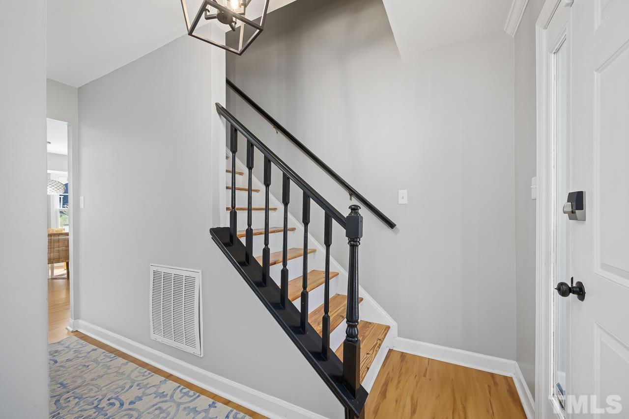 4308 Hickory Ridge Drive Raleigh, NC 27609 - Photo 2 of 46 a view of staircase with wooden floor and white walls