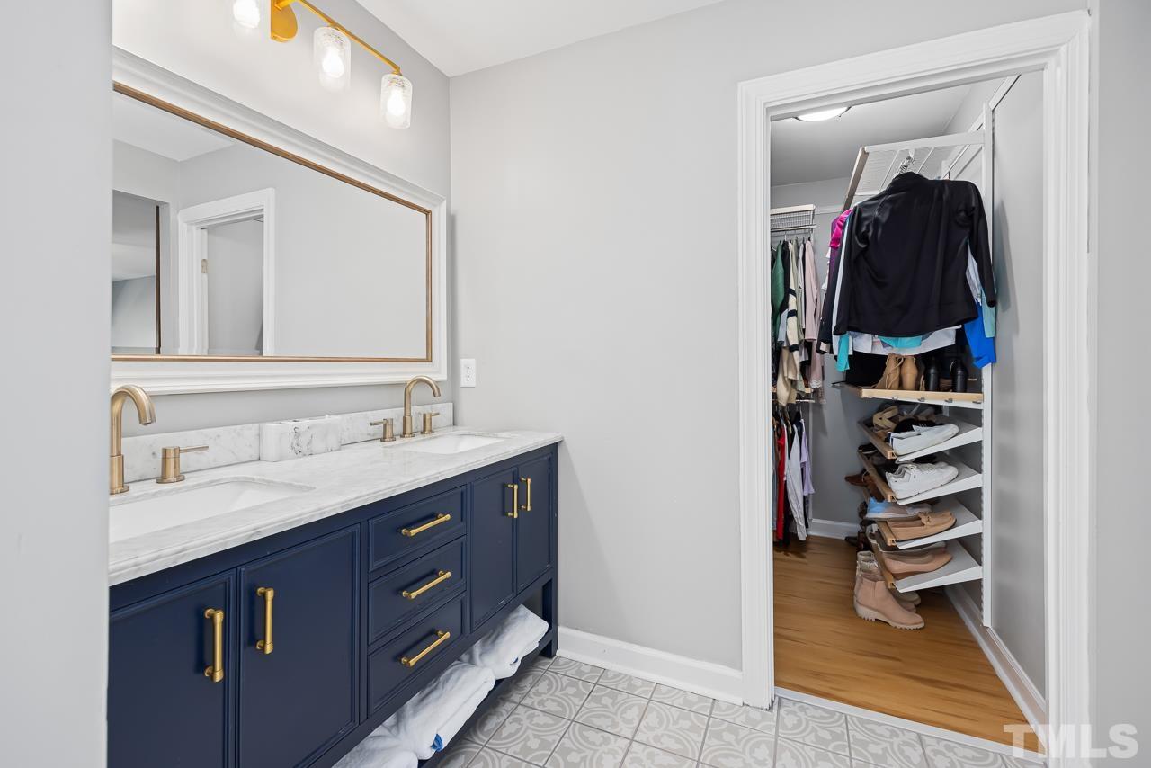 4308 Hickory Ridge Drive Raleigh, NC 27609 - Photo 21 of 46 a bathroom with a sink vanity and mirror