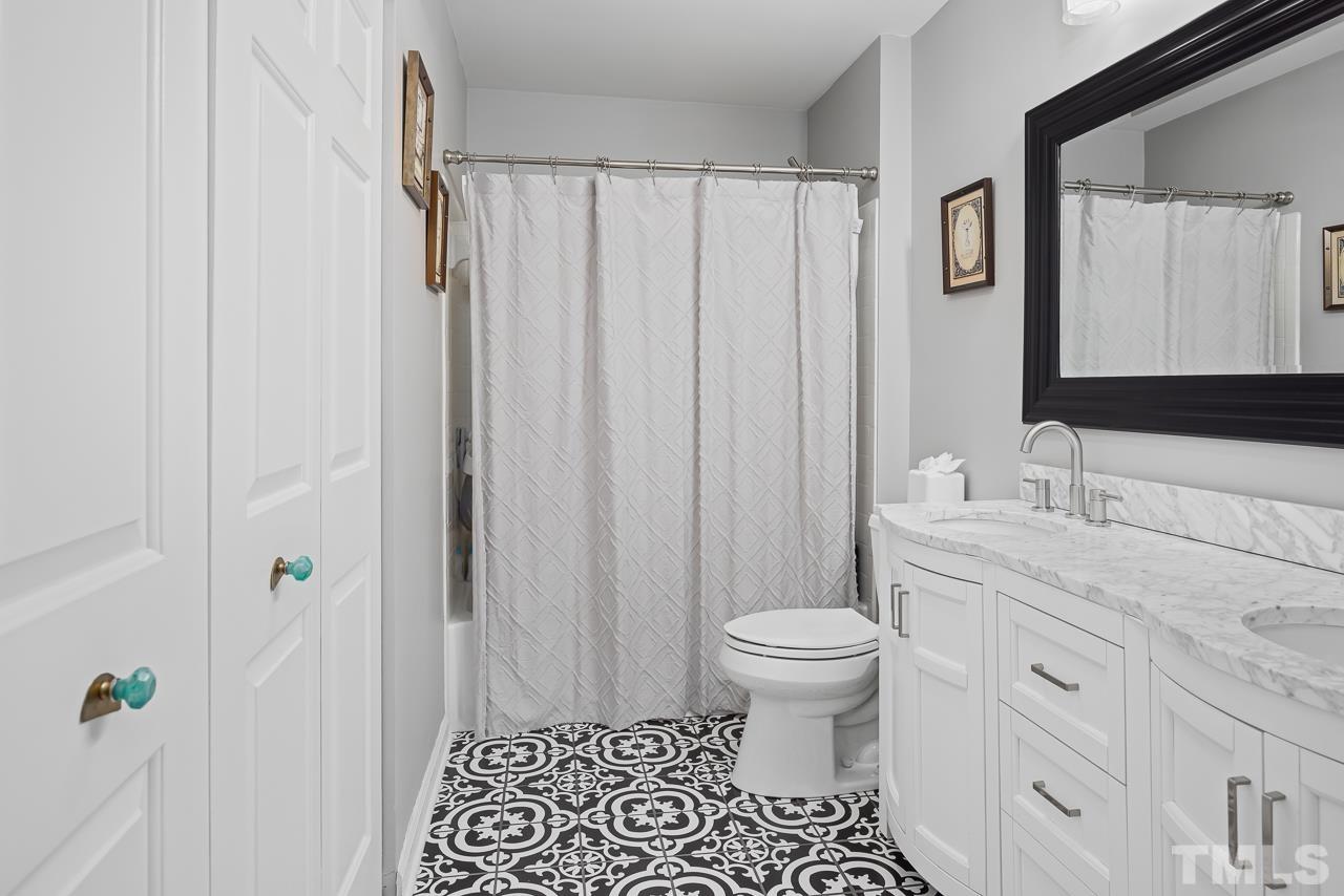 4308 Hickory Ridge Drive Raleigh, NC 27609 - Photo 26 of 46 a bathroom with a granite countertop sink toilet and shower