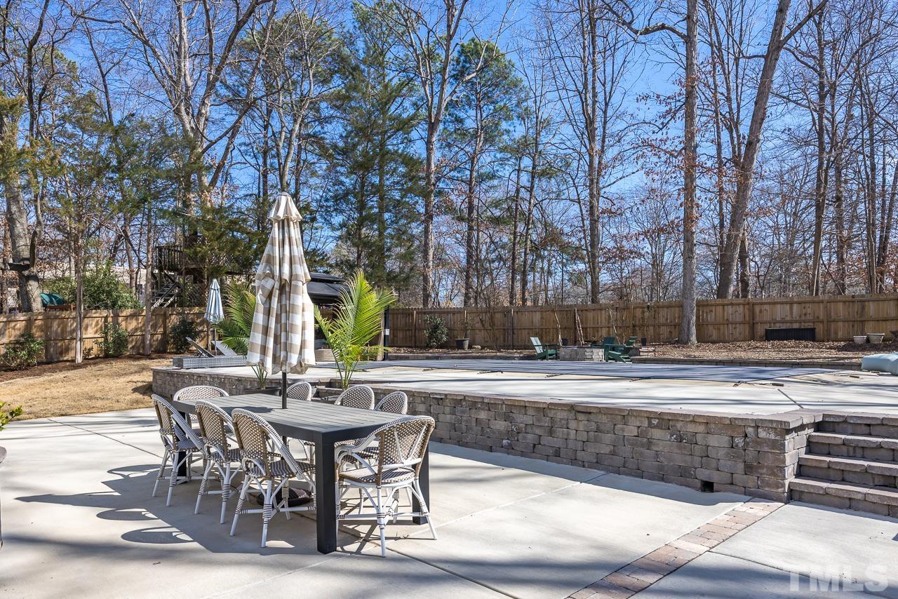 4308 Hickory Ridge Drive Raleigh, NC 27609 - Photo 29 of 46 a view of a swimming pool with a table and chairs