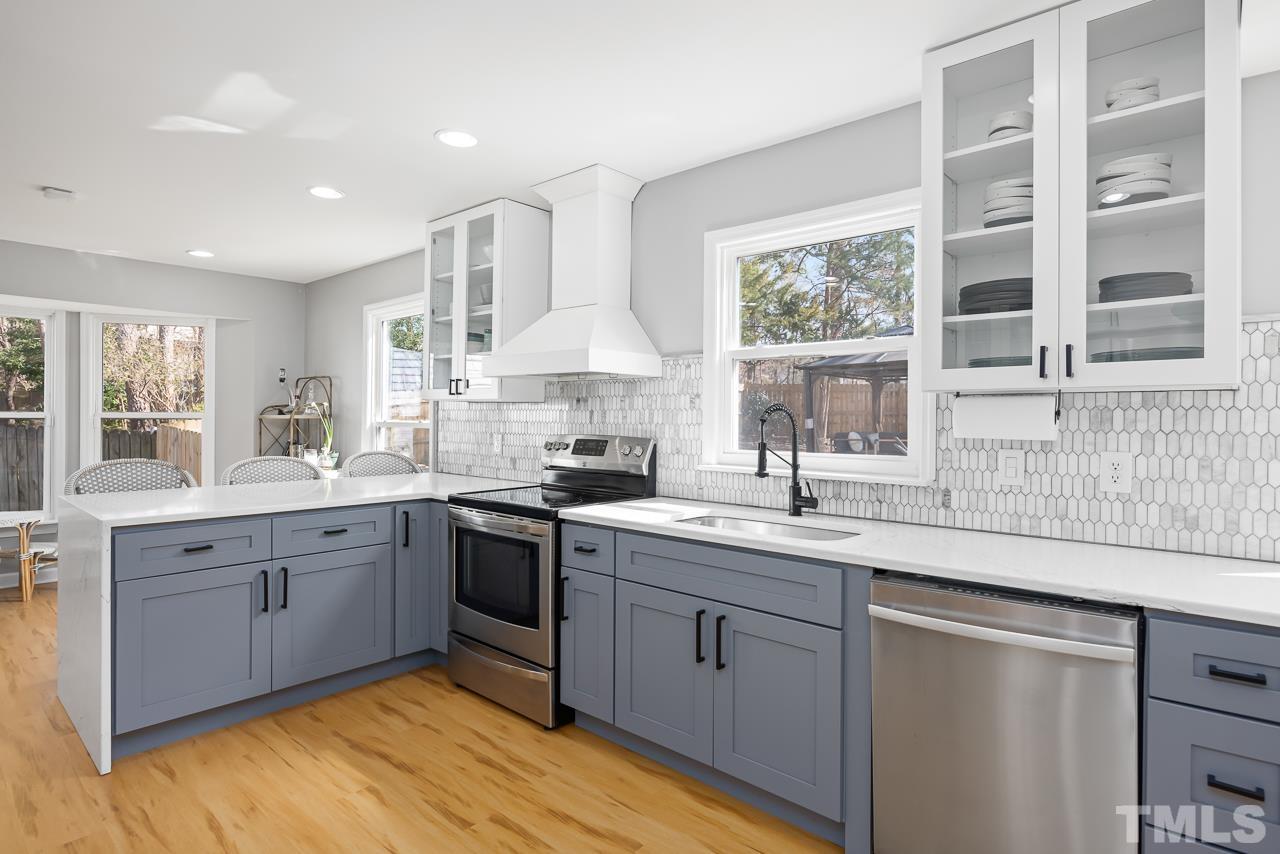 4308 Hickory Ridge Drive Raleigh, NC 27609 - Photo 9 of 46 a kitchen with a sink cabinets and window