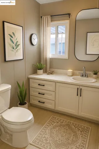 a bathroom with a granite countertop toilet sink and mirror