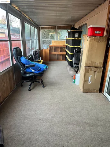 a view of a room with gym equipment and a large window