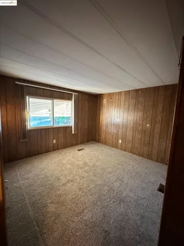 an empty room with windows and closet in a room