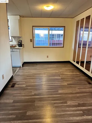 a view of a kitchen with wooden floor and a sink